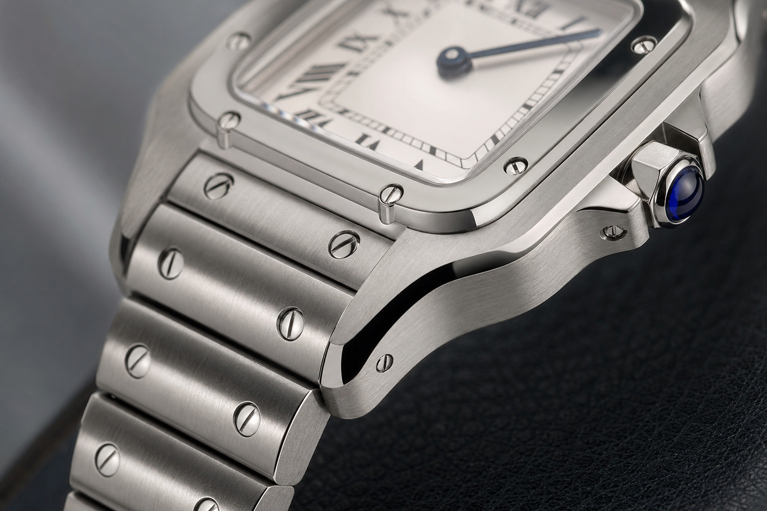 Close up of Santos style steel bracelet bezel screws and blue crown detail